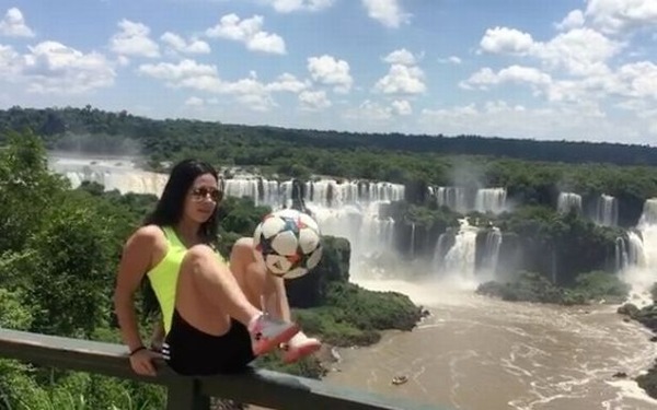 Sexy-girl-shows-off-keepy-uppy-skills-by-waterfall